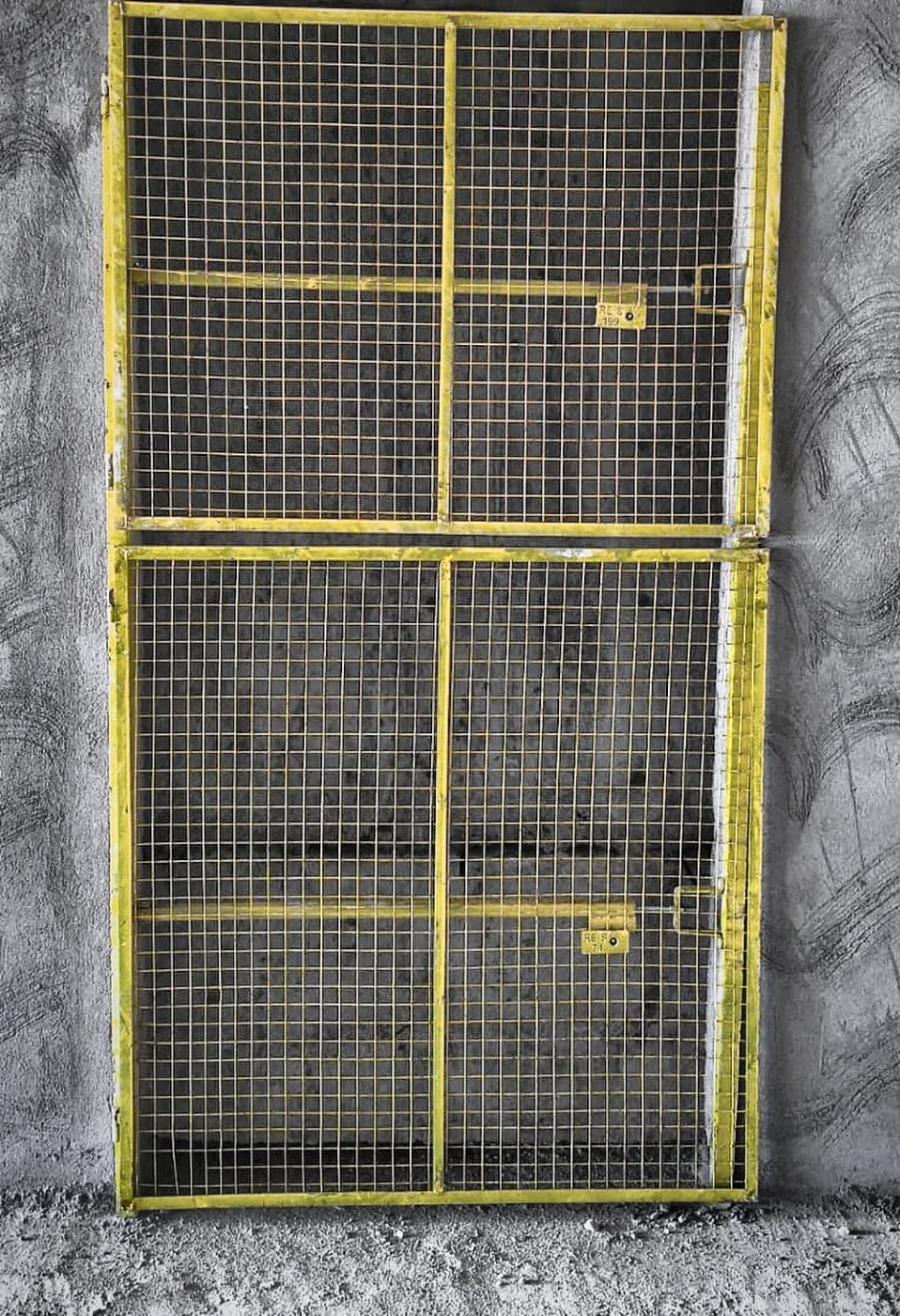 Yellow double-door mesh barricade standing at a landing